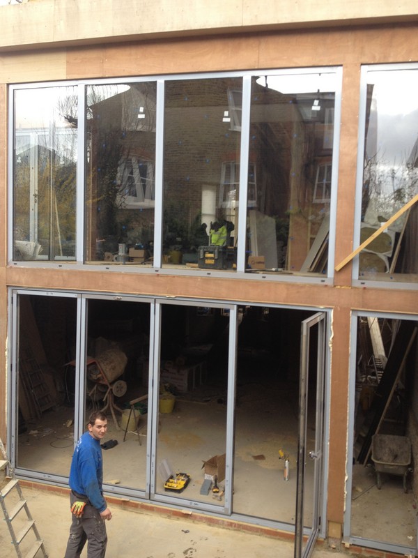 Aluminium bi-fold doors with two-storey glazing in Swiss Cottage