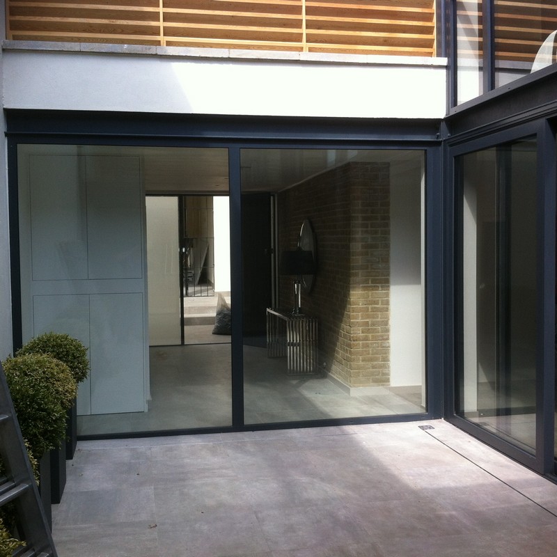 Floor-to-ceiling sliding doors opening to courtyard in Swiss Cottage